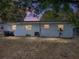 Exterior shot showcasing the back of the house with windows and a grassy area at 1205 Crestwood Dr, Winter Haven, FL 33881