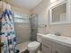 Bathroom featuring a glass shower, patterned shower curtain, and a modern sink at 1205 Crestwood Dr, Winter Haven, FL 33881