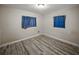 Cozy bedroom featuring wood-look flooring and a neutral color palette, perfect for relaxation at 1205 Crestwood Dr, Winter Haven, FL 33881