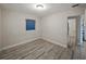 This is a bedroom featuring modern gray wood floors and a window at 1205 Crestwood Dr, Winter Haven, FL 33881