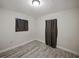 Bedroom with wood-look flooring, neutral walls, and window with curtains at 1205 Crestwood Dr, Winter Haven, FL 33881