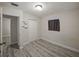 Bedroom with wood-look floors, closet, and window for natural light at 1205 Crestwood Dr, Winter Haven, FL 33881