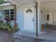 Close up of front door and front parking of single-story house with drought resistant landscaping at 1205 Crestwood Dr, Winter Haven, FL 33881