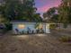 Charming single-story home with well-maintained landscaping and a covered entry during a beautiful dusk at 1205 Crestwood Dr, Winter Haven, FL 33881