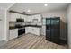 Updated kitchen featuring stainless steel appliances, granite countertops, and white cabinetry at 1205 Crestwood Dr, Winter Haven, FL 33881