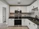 Modern kitchen with stainless steel microwave and oven with granite countertops at 1205 Crestwood Dr, Winter Haven, FL 33881