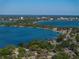 Scenic view of an expansive waterfront with distant cityscape and residential areas at 1205 Crestwood Dr, Winter Haven, FL 33881