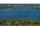 Large body of water view lined with trees, residences and a boat in the distance at 1205 Crestwood Dr, Winter Haven, FL 33881