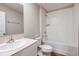 Bright bathroom featuring a white vanity, toilet, and tiled shower-tub combo at 1752 Frogmore Ave, Haines City, FL 33844