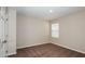 A cozy bedroom with neutral walls, brown carpet, and a window for natural light at 1752 Frogmore Ave, Haines City, FL 33844