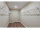 Empty walk-in closet with built in shelving at 1752 Frogmore Ave, Haines City, FL 33844