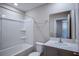 Bathroom with a shower/tub combo and a gray vanity with a large mirror at 1756 Frogmore Ave, Haines City, FL 33844