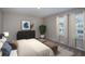 Calming bedroom with natural light from two windows, neutral tones, and minimalist decor at 1756 Frogmore Ave, Haines City, FL 33844