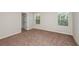 Empty bedroom with carpeted floor, large windows, and closet space at 1760 Frogmore Ave, Haines City, FL 33844