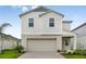 Charming two-story home featuring a two-car garage, landscaped yard, and a welcoming covered entry at 1760 Frogmore Ave, Haines City, FL 33844