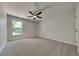 Bedroom featuring plush carpet, ceiling fan, closet, and natural light through a window at 210 Alta Vista St, Debary, FL 32713
