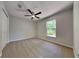 Bedroom featuring plush carpet, a ceiling fan, closet, and a window view of the outdoors at 210 Alta Vista St, Debary, FL 32713