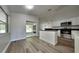 Modern kitchen with an island, white cabinets, stainless steel appliances, and sliding glass doors nearby at 210 Alta Vista St, Debary, FL 32713