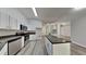 Modern kitchen with white cabinets, stainless steel appliances, and a large island for food preparation at 210 Alta Vista St, Debary, FL 32713