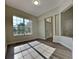 Bright and spacious living room with large windows and wood-look flooring at 210 Alta Vista St, Debary, FL 32713