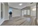 Open-concept living room featuring wood-look flooring, neutral paint, and direct access to the kitchen at 210 Alta Vista St, Debary, FL 32713