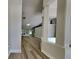 Open living space with wood-look floors and decorative architectural columns leading to the rear living area at 210 Alta Vista St, Debary, FL 32713