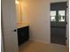 Stylish powder room with a modern vanity and dark hardware, next to bedroom at 6069 Sacred Oak Ave, Mount Dora, FL 32757