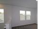 Cozy bedroom featuring plush carpet and multiple windows for lots of natural light at 6069 Sacred Oak Ave, Mount Dora, FL 32757