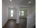 Elegant entryway with dark laminate flooring and neutral color palette throughout at 6069 Sacred Oak Ave, Mount Dora, FL 32757