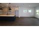 Modern kitchen boasts a large island, stainless steel appliances, and stylish pendant lighting at 6069 Sacred Oak Ave, Mount Dora, FL 32757
