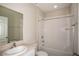 Clean bathroom with white tiled shower/tub combination, a vanity with a sink, and a large mirror at 1046 Foreshore Ln, Haines City, FL 33844