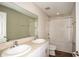 Bright bathroom with a double sink vanity, a large mirror, and a shower-tub combination at 1046 Foreshore Ln, Haines City, FL 33844