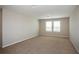 Large bedroom featuring plush carpeting, neutral walls and plenty of natural light from the two windows at 1046 Foreshore Ln, Haines City, FL 33844