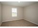 This is a cozy bedroom that features neutral-toned walls and carpet, and a large window at 1046 Foreshore Ln, Haines City, FL 33844