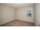 Cozy bedroom featuring neutral paint, carpet flooring, and a window for natural light at 1046 Foreshore Ln, Haines City, FL 33844
