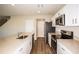 Modern kitchen with stainless steel appliances, white cabinetry, and quartz countertops at 1046 Foreshore Ln, Haines City, FL 33844