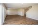 Open-concept living room featuring wood-look flooring, neutral walls and staircase access to the upper level at 1046 Foreshore Ln, Haines City, FL 33844