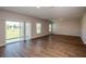 Spacious living room with hardwood floors, recessed lighting, and a sliding glass door to the backyard at 1046 Foreshore Ln, Haines City, FL 33844