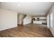 Open-concept view of the living room and kitchen with wood-look floors and recessed lighting at 1046 Foreshore Ln, Haines City, FL 33844