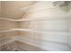 Spacious walk-in pantry with wire shelving, offering ample storage for groceries and household essentials at 1046 Foreshore Ln, Haines City, FL 33844