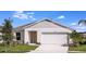 Charming single-story home featuring a two-car garage, well-manicured lawn, and beautiful landscaping at 1590 Sage Ave, Haines City, FL 33844