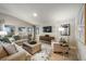 Bright living room with neutral tones, plush seating, a decorative rug, and a large window at 1590 Sage Ave, Haines City, FL 33844