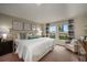 Serene main bedroom featuring a plush bed, large windows, and soft, inviting decor at 1590 Sage Ave, Haines City, FL 33844