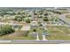 This is an aerial view of a quaint community featuring lovely homes, well-maintained lawns, and mature trees at 326 Marion Oaks Trl, Ocala, FL 34473