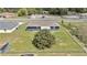 View of the backyard with a well-maintained lawn and a large tree, all enclosed by a chain-link fence at 326 Marion Oaks Trl, Ocala, FL 34473