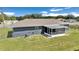 Backyard view with screened in patio attached to the house at 326 Marion Oaks Trl, Ocala, FL 34473