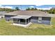 Backyard view with screened in patio attached to the house at 326 Marion Oaks Trl, Ocala, FL 34473