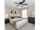 This bedroom has a ceiling fan, neutral paint color, and an upholstered headboard with decorative pillows at 326 Marion Oaks Trl, Ocala, FL 34473