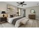 This bedroom has a ceiling fan, neutral paint color, and an upholstered headboard with decorative pillows at 326 Marion Oaks Trl, Ocala, FL 34473