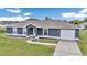 Charming single-story home featuring a well-maintained lawn and paved driveway at 326 Marion Oaks Trl, Ocala, FL 34473